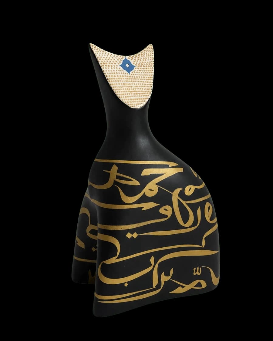 Matte-black ceramic vessel with gold Persian calligraphy and a gold-dotted collar